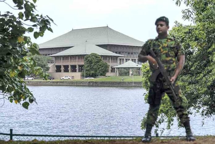 Army soldier stands guard outside parliament house in Colombo